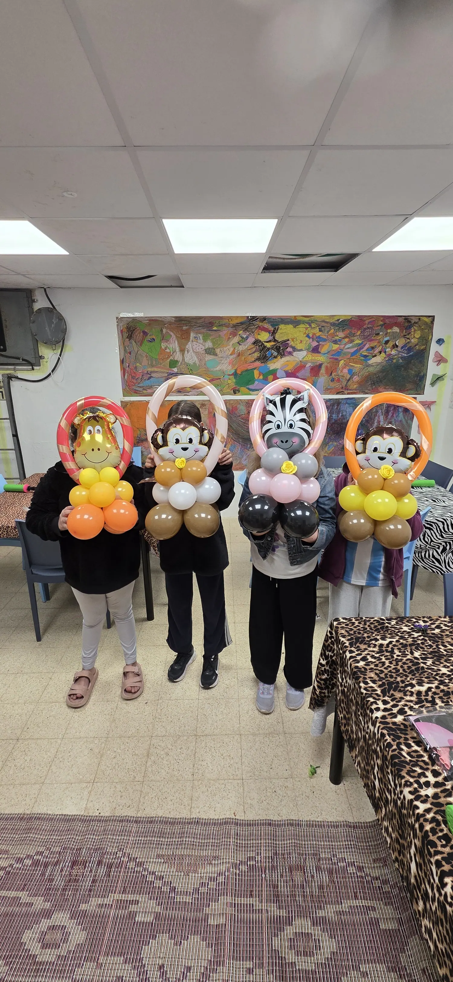 משתתפים מציגים את דמויות הבלונים שיצרו בסדנה